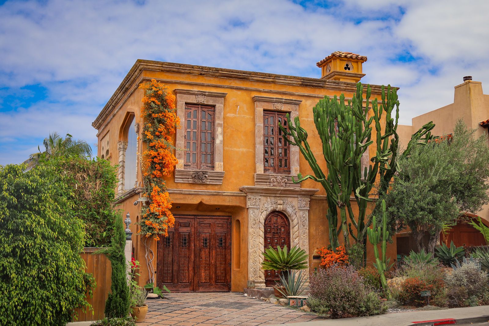 Real Mediterranean-style home exterior in San Diego with an ornate facade and mature garden
